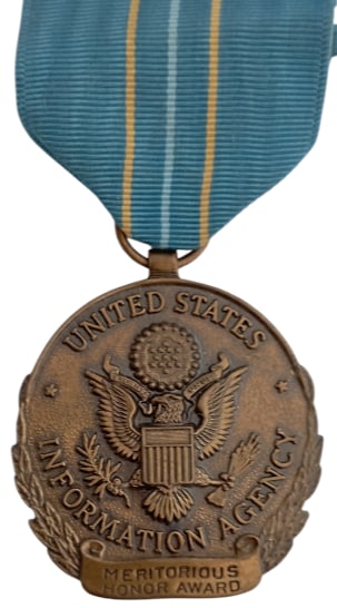 The United States Information Agency (USIA) Meritorious Honor Award: Breast Badge, 42x37 mm, Bronze, original suspension ring and ribbon. Mint state!