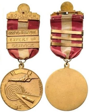 BOULDER RIFLE AND PISTOL CLUB: BOULDER RIFLE AND PISTOL CLUB "3 Clasps 600 Yd. Slow Fire, Expert 1st Service". Breast Badge, 46 mm, gilt Bronze, original suspension ring and ribbon. I