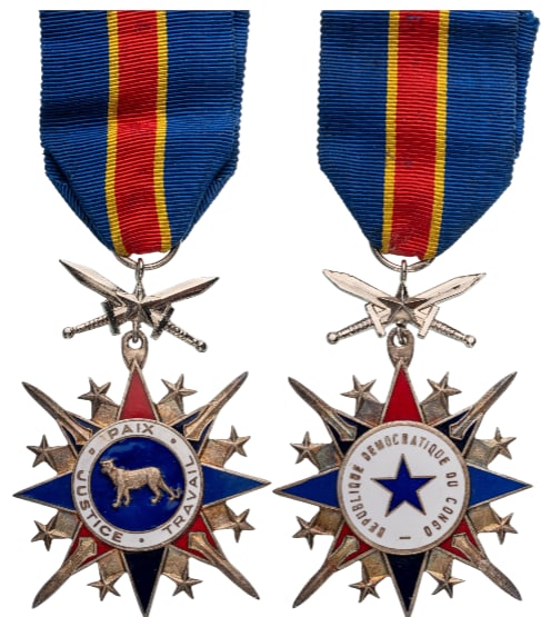National Order of the Leopard: Knight's Cross, 5th Class, instituted in 1966. Breast Badge, 66x47 mm., silvered Bronze, original suspension swords, ring and ribbon. An attractive badge, in extremely fine condition! I