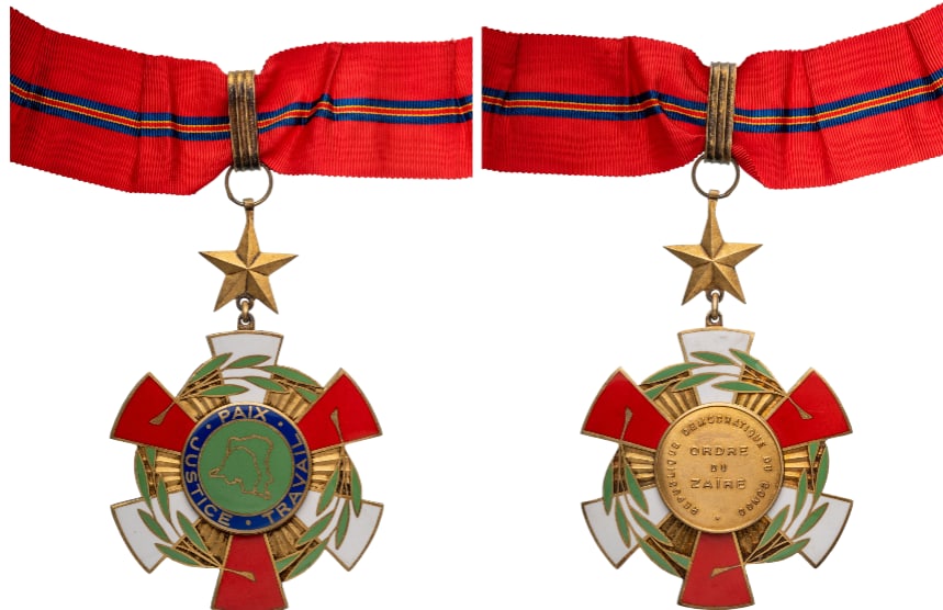 National Order of Zaire: Commander's Cross, 3rd Class, instituted in 1968. Neck Badge, 105x75 mm., gilt Silver, original suspension ring, star, loop and ribbon. A very imposing badge, in extremely fine condition! I
