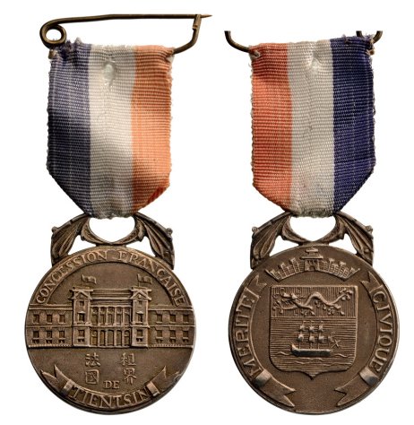 TIENTSIN MEDAL OF CIVIC MERIT: Country: CHINA 2nd Class (French Concession). Breast Badge, 38x32 mm, silver, original suspension device and ribbon. Extremely rare medal awarded during the period of the foreign powers in Shanghai. E