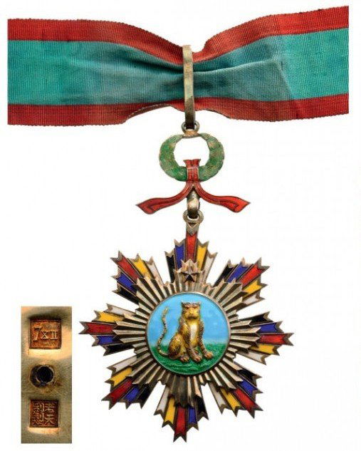 ORDER OF THE STRIPED TIGER: Country: CHINA Commander's Cross, 3rd Class. Neck Badge, 103 mm, gilt Silver, Chinese maker's marks, one side enameled, original suspension device, loop and complete ribbon. Rare and in perfect condi