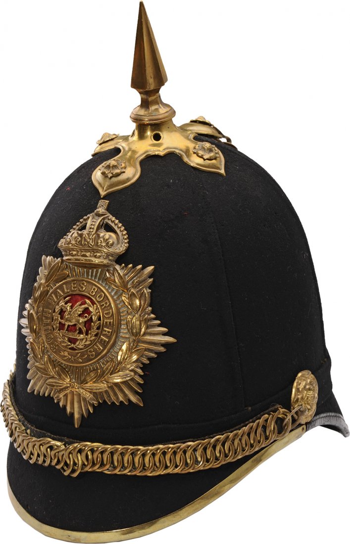 Victorian Officerâ€™s 1879: Blue Cloth Helmet to the South Wales Borderers with brass fluted spike gilt metal helmet plate with Edward VII crown ear rosettes leather backed chin scales and brass bound front brim with tan leather