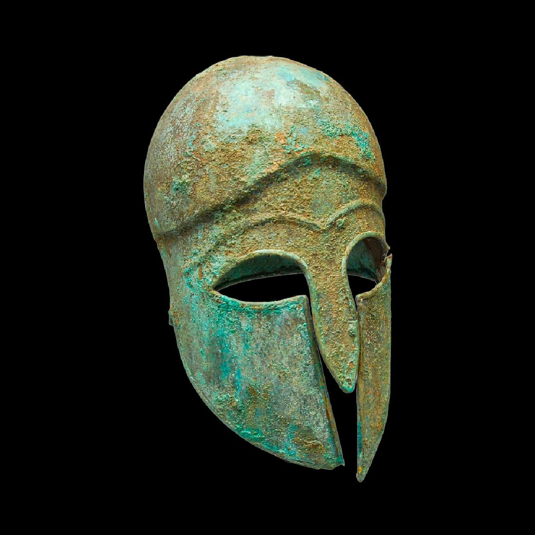 A Corinthian helmet. Ancient Greece. 3-5 century BC: Corinthian helmet. In the style of Ancient Greece. 3-5 century BC.Bronze, patina. Crack in one ear.