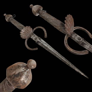 A LARGE ITALIAN LEFT HAND DAGGER, 17TH CENTURY.: A LARGE ITALIAN LEFT HAND DAGGER, 17TH CENTURY. Straight double-edged steel blade. Guard with flattened ends and a shell-shaped protective shield. Wooden handle wrapped with silver wire, steel