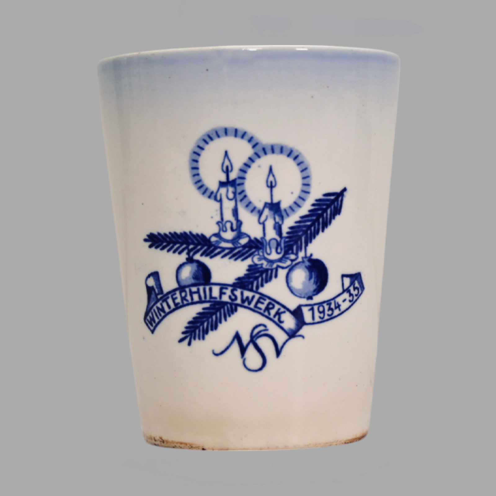 Glazed stoneware mug, lettering "Winterhilfswerk 1934/35 NSV", Manufactory Waechtersbach.: Glazed stoneware mug featuring a motif of a fir branch with a bauble and burning candles, accompanied by the lettering "Winterhilfswerk 1934/35 NSV". Manufactured by Waechtersbach. The Winterhilfswerk