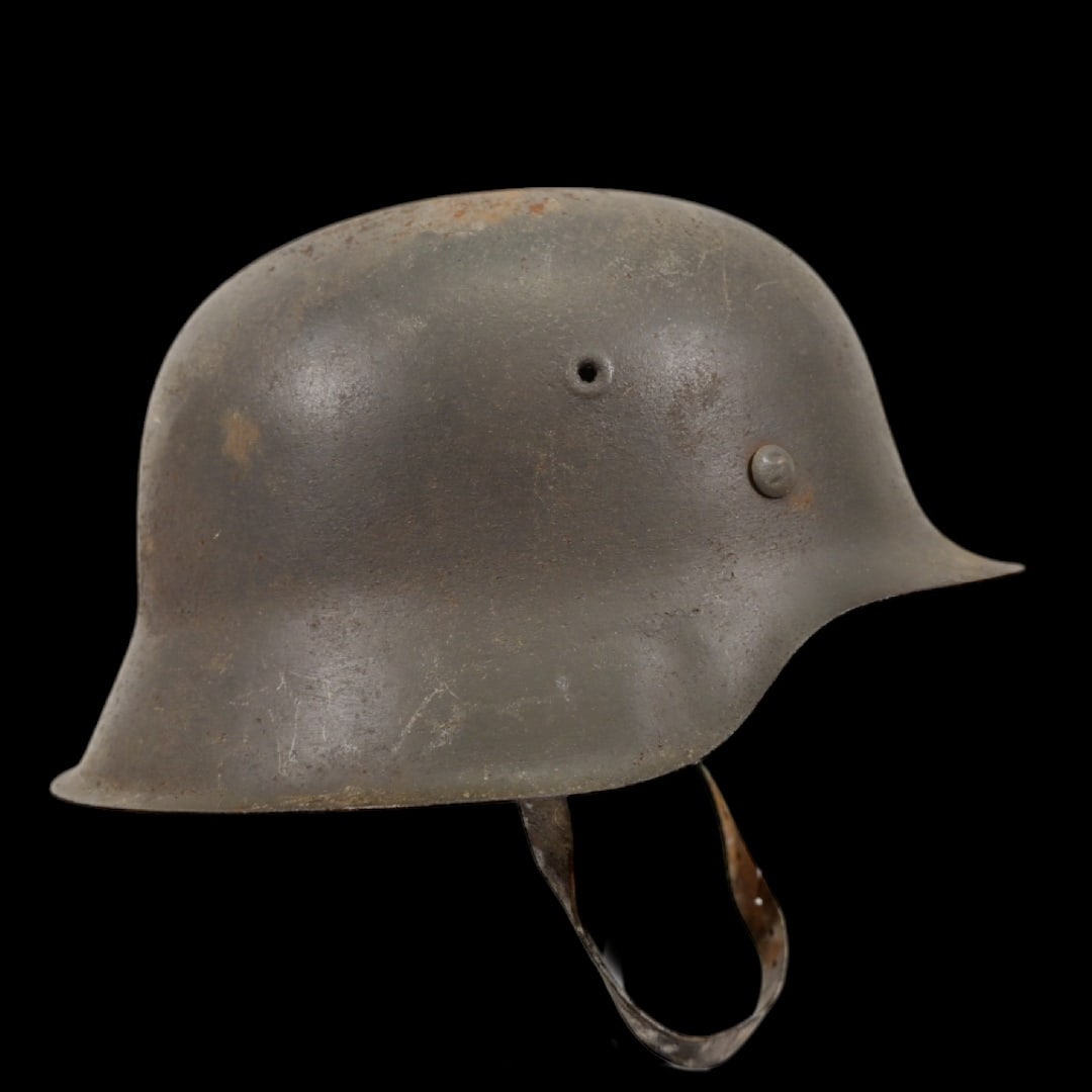 WWII Nazi German M42 Combat Helmet complete with liner and chin strap.