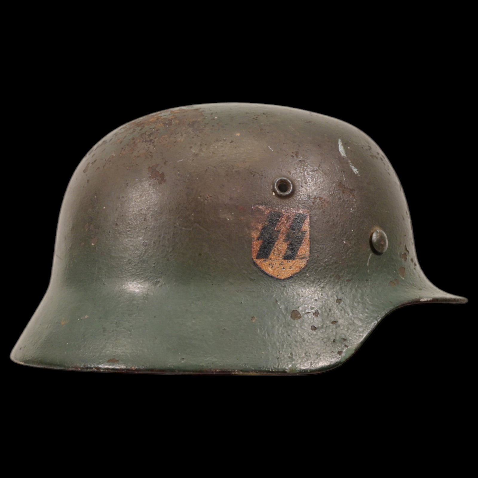 WWII Nazi German M40 SS Combat Helmet in camouflage paint, SS emblem.: WWII Nazi German M40 SS Combat Helmet in camouflage paint, SS emblem. The SS emblem on the right side of the helmet is well preserved. This helmet is a significant piece of WWII militaria. It is an ex