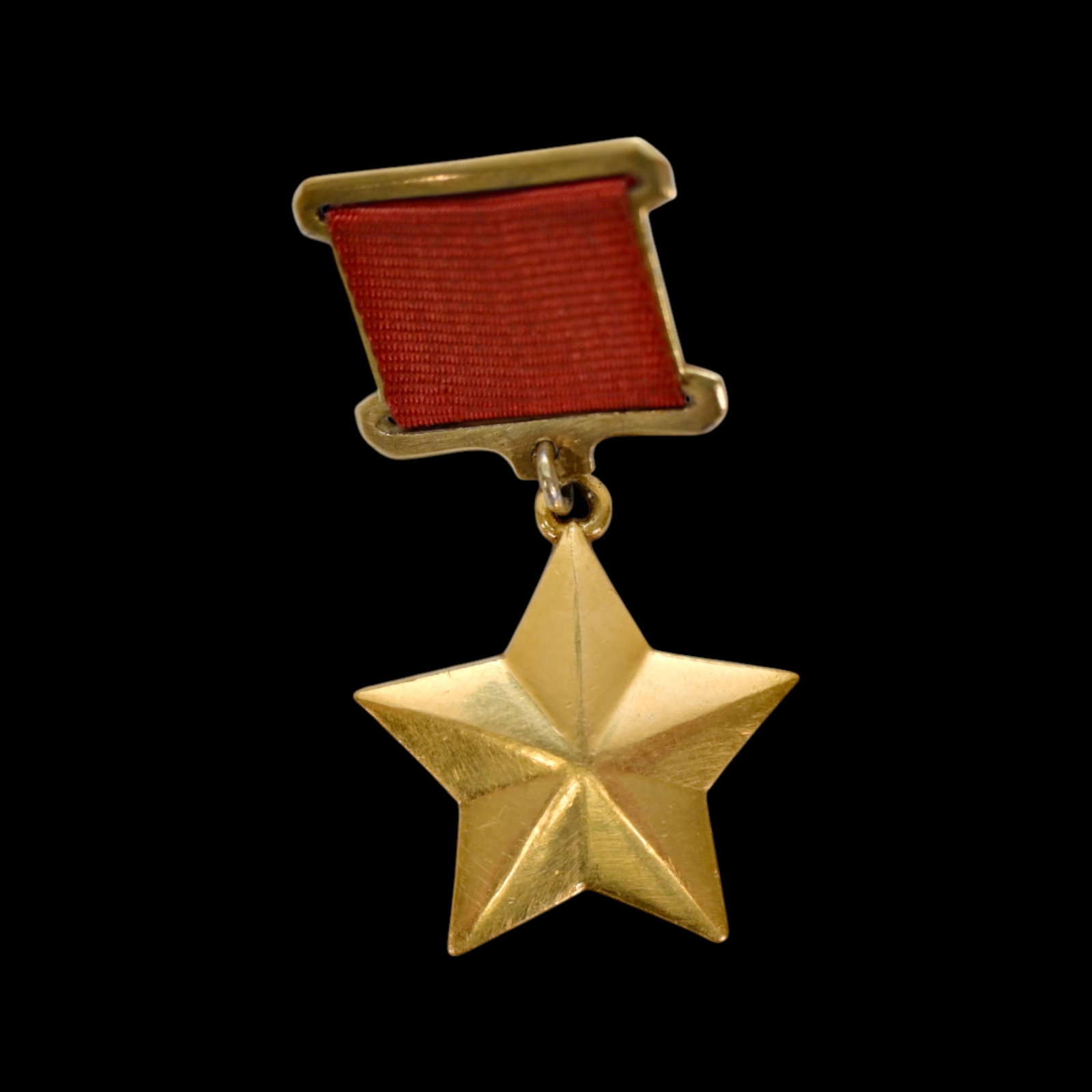 Gold Star of the Hero of the Soviet Union, No 2418, Union of Soviet Socialist Republics (USSR), 1944: Gold Star of the Hero of the Soviet Union, No 2418, Union of Soviet Socialist Republics (USSR), 1944. A solid gold five-pointed star suspended from a rectangular gilt suspension with red ribbon. Rever