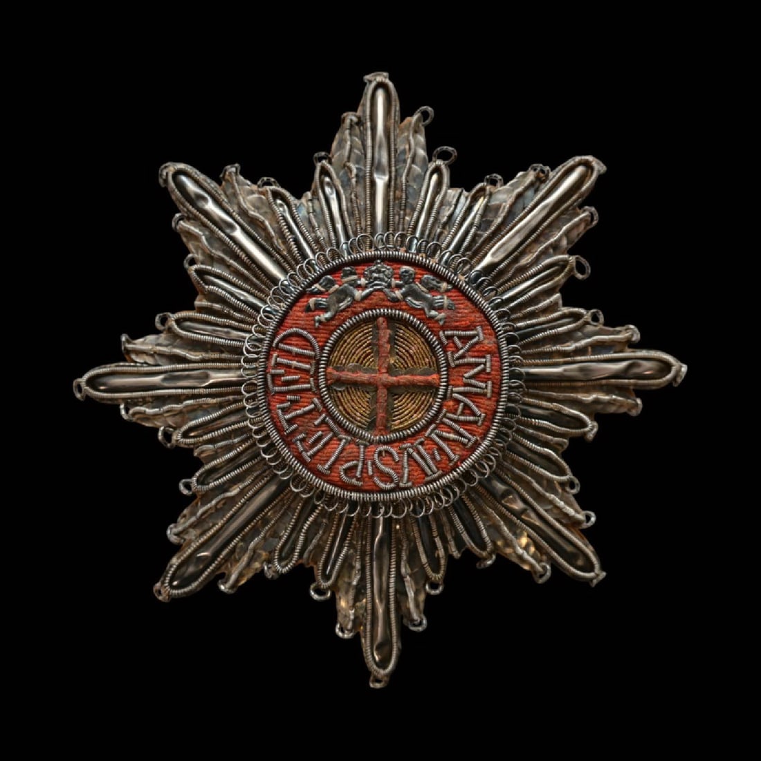 Embroidered Silver Breast Star of the Order of Saint Anna, 1st Class, Russia.: Embroidered Silver Breast Star of the Order of Saint Anna, 1st Class, Russia. Executed in silver thread and filigree wirework, with a central medallion bearing the red-embroidered cross of Saint Anna 