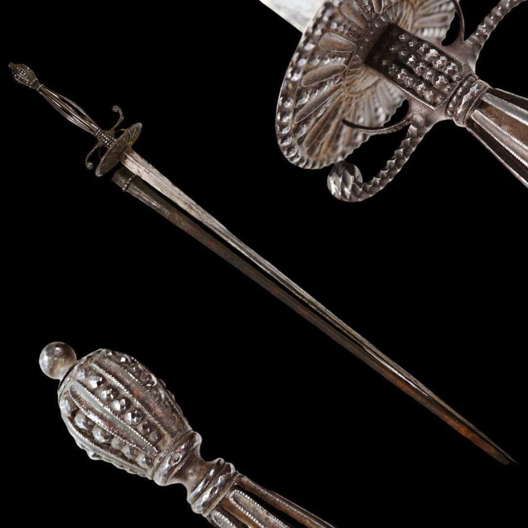 A French small-sword with cut steel hilt, 1770 - 1790.: A French small-sword with cut steel hilt, 1770 - 1790. Incurved triangular section blade, decorated with military trophies and floral ornament. The hilt is decorated with cut steel beads. Black leathe