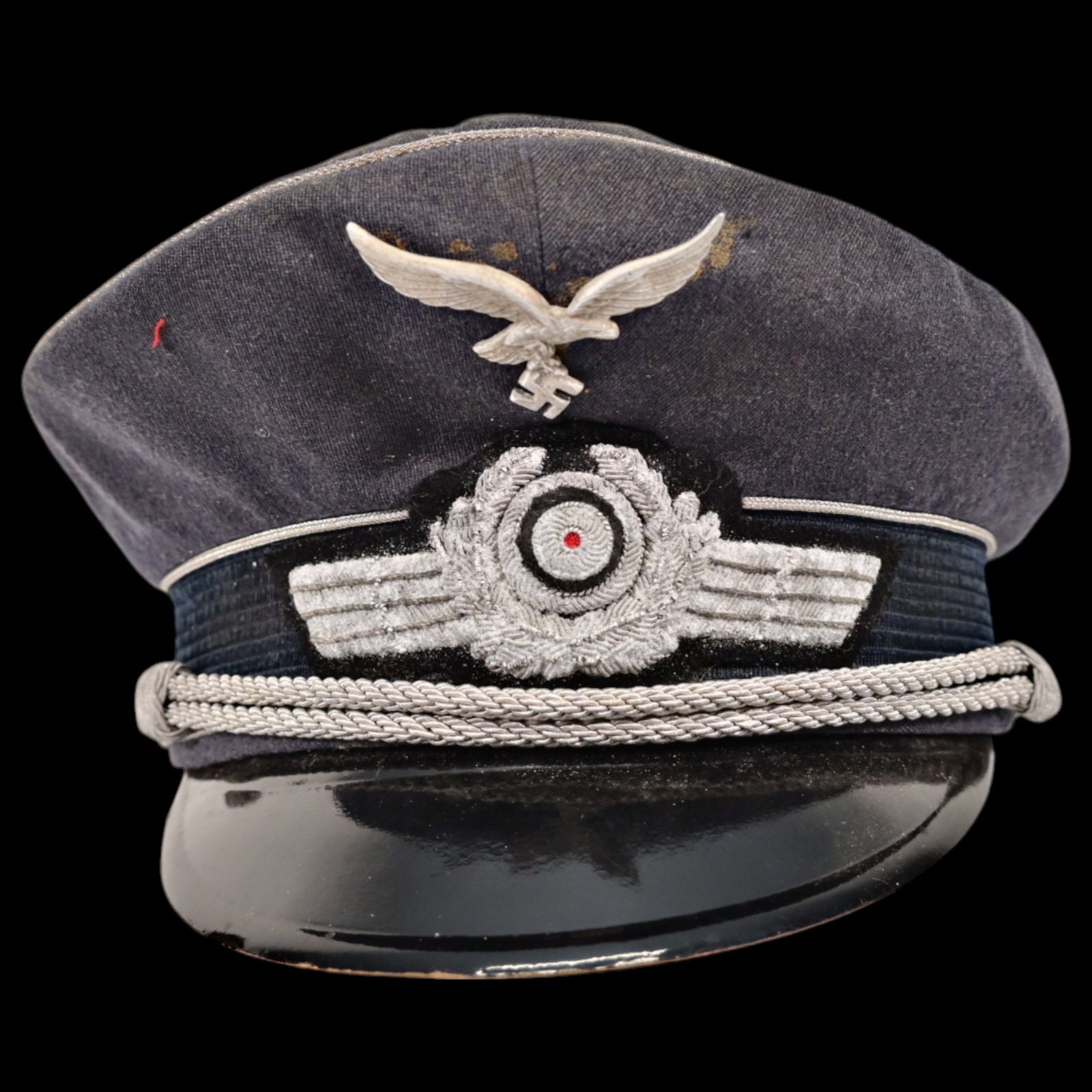 WWII Nazi Luftwaffe officer's cap.: WWII Nazi Luftwaffe officer's cap. This authentic piece of World War II German military attire is a well-preserved example of an officer's uniform accessory. The cap features the iconic Luftwaffe insi