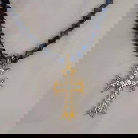 925 Silver Black Stone Bead Golden Cross Necklace: Golden cross necklace adorned with black beads and gemstones.Necklace material: Black ore, with the top part made of 925 silverCross design: Ornamental cross with stone decorationsThe top part of the