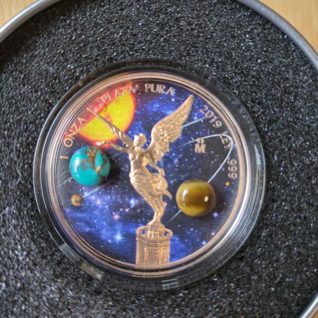 2019 Mexico Statue of Liberty 1 oz Silver Coin, Limited Edition of 500 Worldwide: This Mexican Statue of Liberty commemorative coin is a special commemorative coin issued in 2019. The coin design features a beautiful space landscape as the background, with a figure of an angel symb