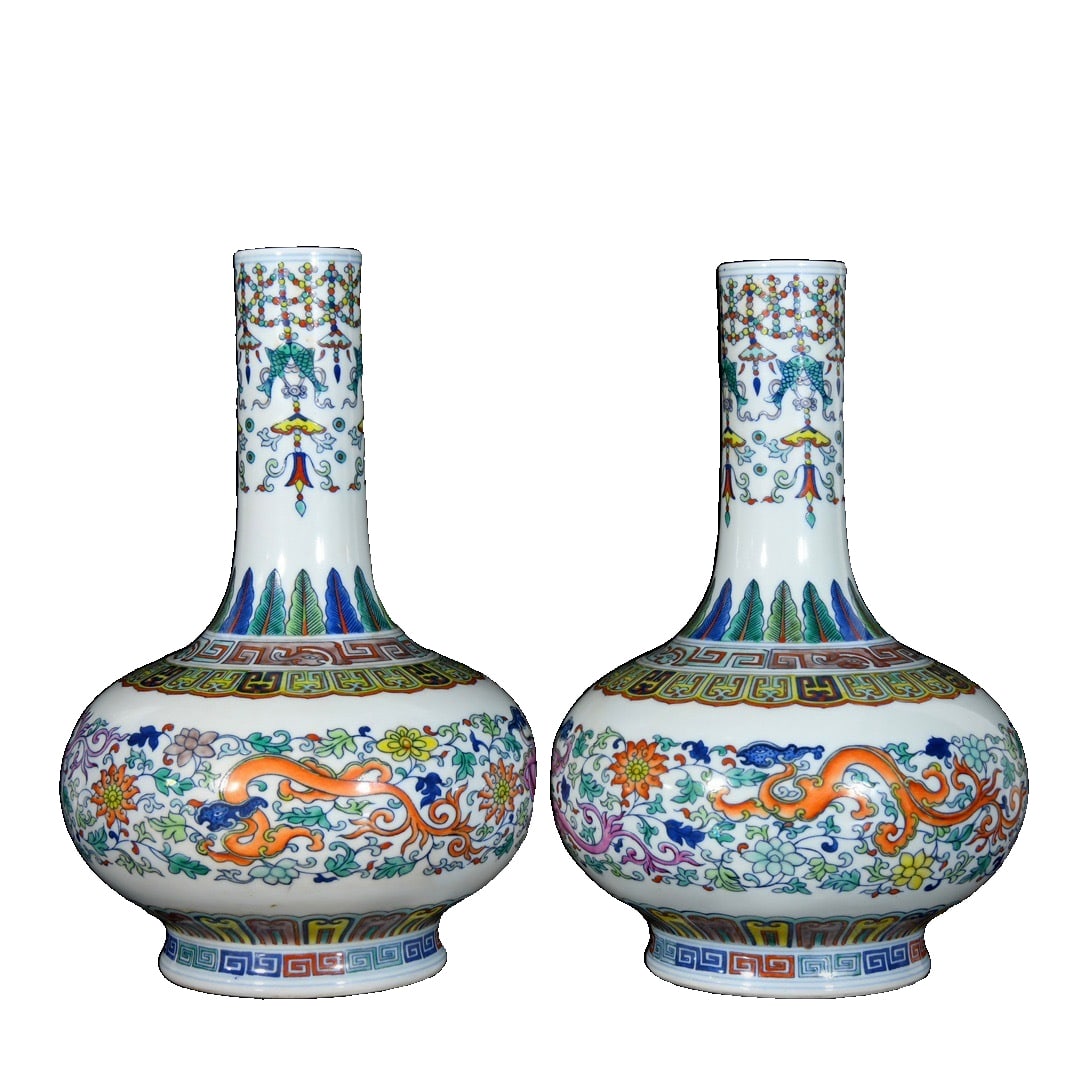 A pair of Qianlong-style famille-rose cinnabar dragon pattern celestial sphere vases; 35x23: This pair of doucai (enamel overglaze enamel) celestial globe vases, bearing the mark of the Yongzheng period of the Qing dynasty, are approximately 35 cm tall and 23 cm in diameter, with an elegant d