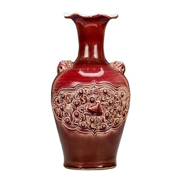 Ming Dynasty style full-body red-glazed carved porcelain with mandarin ducks and floral patterns,: A Ming dynasty style red glazed porcelain vase with embossed peony design and animal head handles. Height 47, width 24 centimeters.The vase in the picture is exquisitely crafted and beautiful, with it