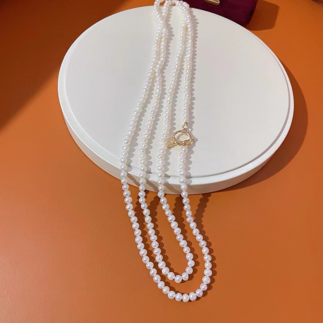 Natural 5mm Freshwater Pearl Necklace Sweater Chain: A versatile sweater chain with natural 5mm freshwater pearls, nearly round and highly lustrous, measuring 120cm in length. These high-quality pearls have minimal flaws, allowing for various wearing
