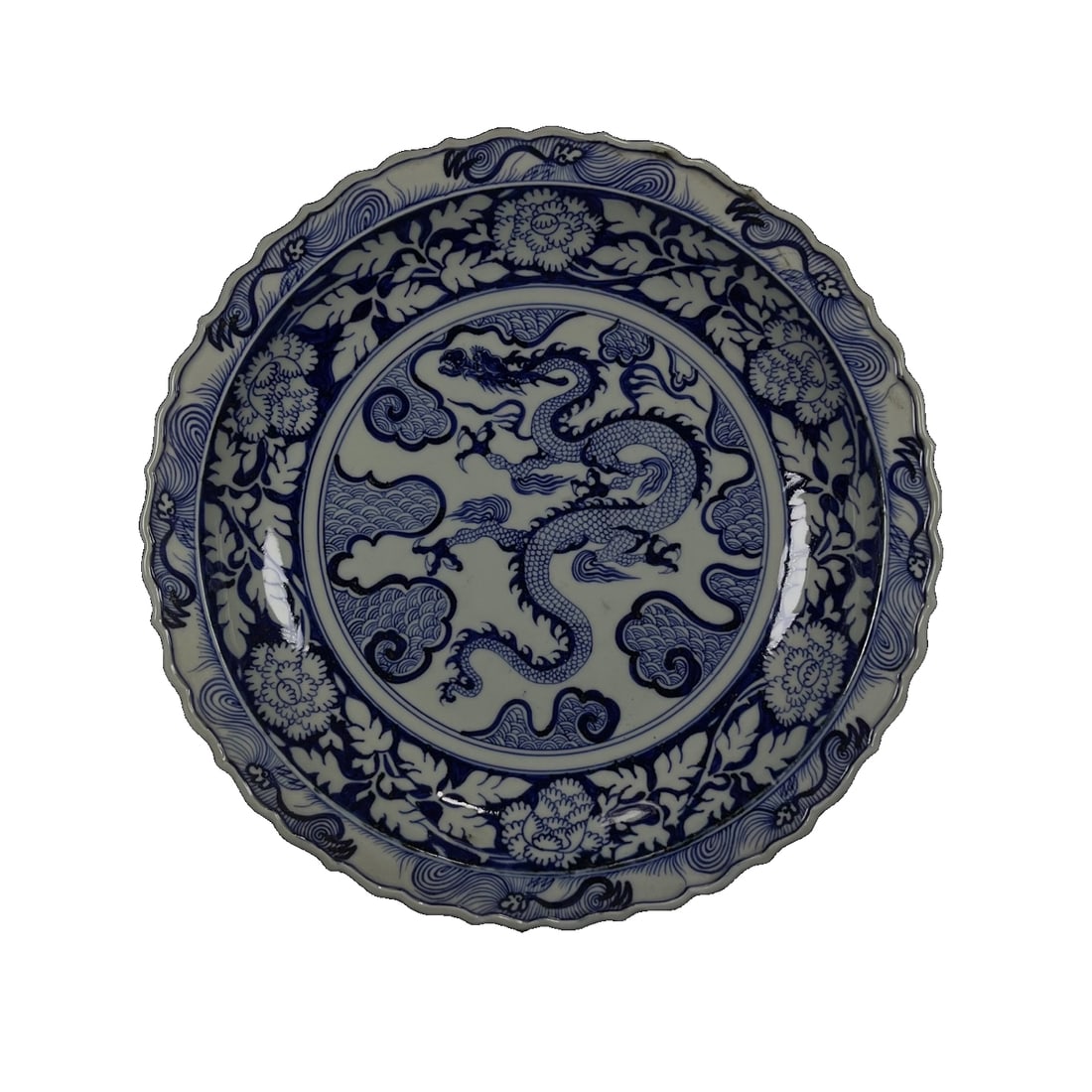 Yuan Blue-and-white Dragon-patterned Large Plate: This Yuan Dynasty blue-and-white dragon plate embodies the pinnacle of porcelain-making techniques from that era. The dragon design, flying across the surface of the plate, is vigorous and lifelike, s