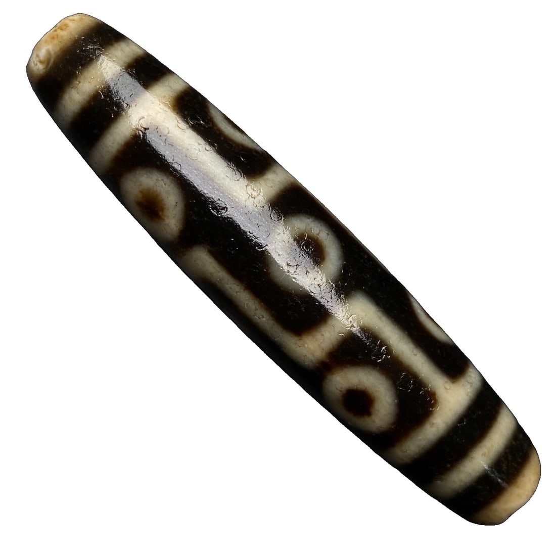 Old Agate Nine-Eyed Dzi Bead: Nine Eyes Tibetan BeadSize: 58x13 mm Weight: 16.1 gramsNine Eyes Tibetan Bead for Good LuckThe Nine Eyes Tibetan Bead brings good fortune in all aspects including career, wealth, health, longevity, an