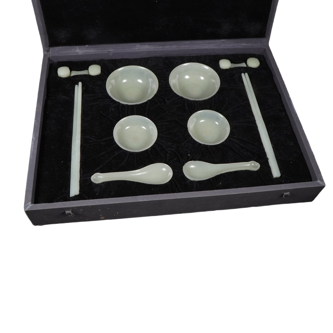 Qing Hetian Jade Tableware Set: The Qing Hetian jade tableware set includes chopsticks 24cm in length, spoons 13.2cm in length, 4.2cm in width, with a diameter of 7.7cm, a height of 2.6cm, bowls with a diameter of 10.2cm and a heigh