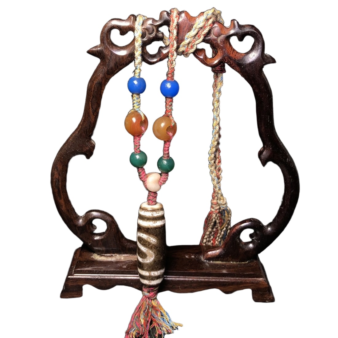 An intricately crafted necklace featuring a celestial bead adorned with gold thread and coins, (1 of 10)