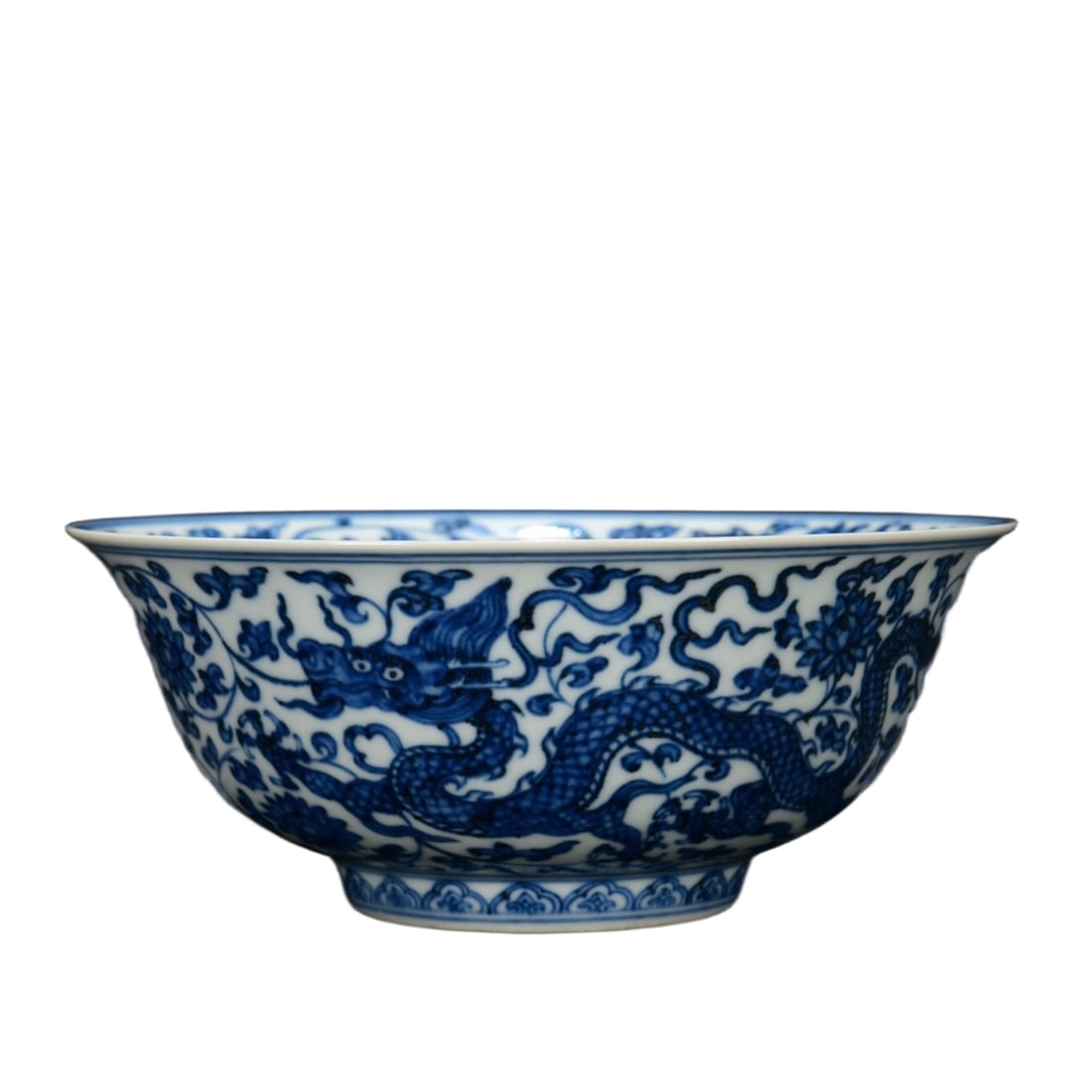 Ming Zhengde blue and white bowl with intertwined dragon design.: This bowl is a blue and white porcelain ware made during the Ming Dynasty, Zhengde period. The shape of the vessel is elegant, with a deep and stable foot, slightly flared rim, and smooth lines. The m