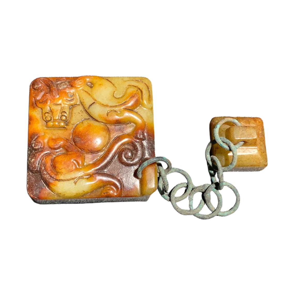 Hetian jade seal bronze ring: This Hetian jade seal is paired with an antique bronze ring, showcasing its elegant beauty through delicate carving. The jade is warm and lustrous, with a smooth carving technique that perfectly combi