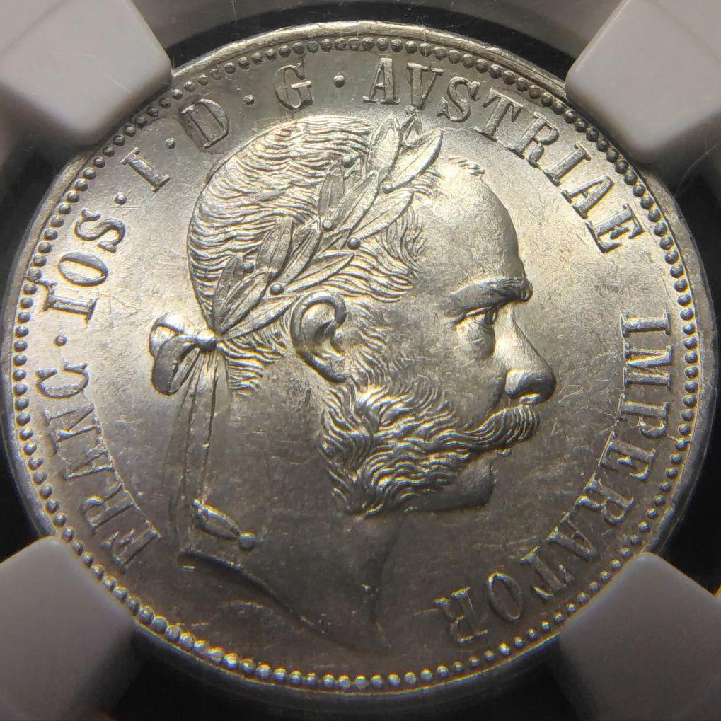 1879 MS 62 "Franz Joseph Florin Silver Coin": This is a silver coin from the era of Emperor Franz Joseph I, highly favored by coin collectors. He was born into the illustrious Habsburg family and was the Emperor of Austria and King of Hungary. He