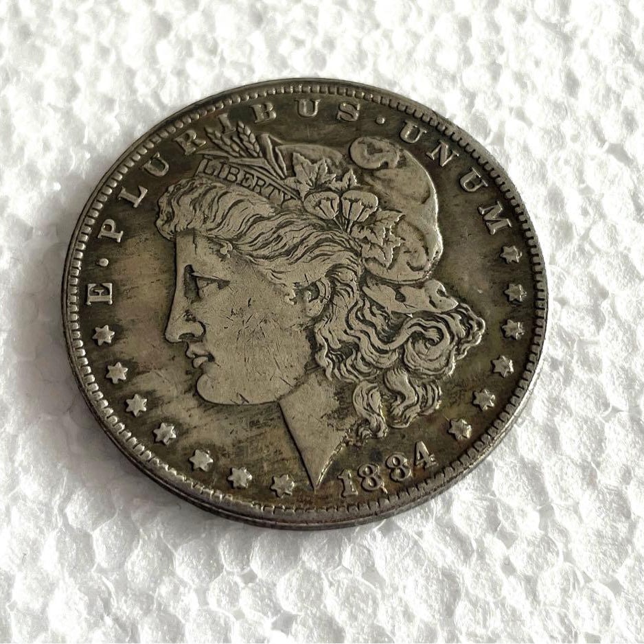 1884 Morgan US $1 coin, large size, approximately 38.1 millimeters (1 of 4)