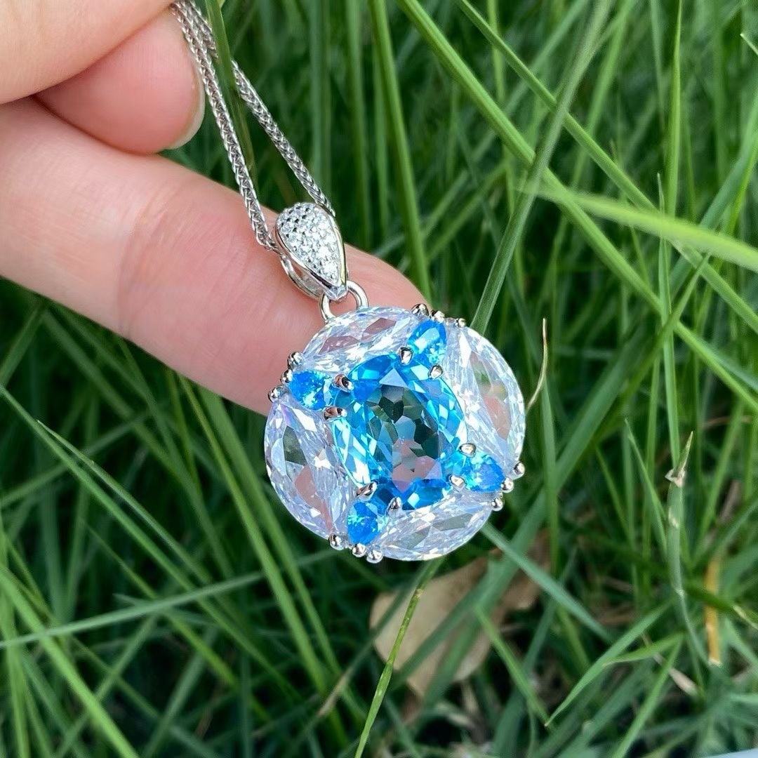 925 silver set with natural topaz pendant: This exquisite pendant showcases the charming natural topaz at its center, revealing an elegant essence. The topaz is set in a delicate s925 silver setting, displaying a captivating blue hue that shim