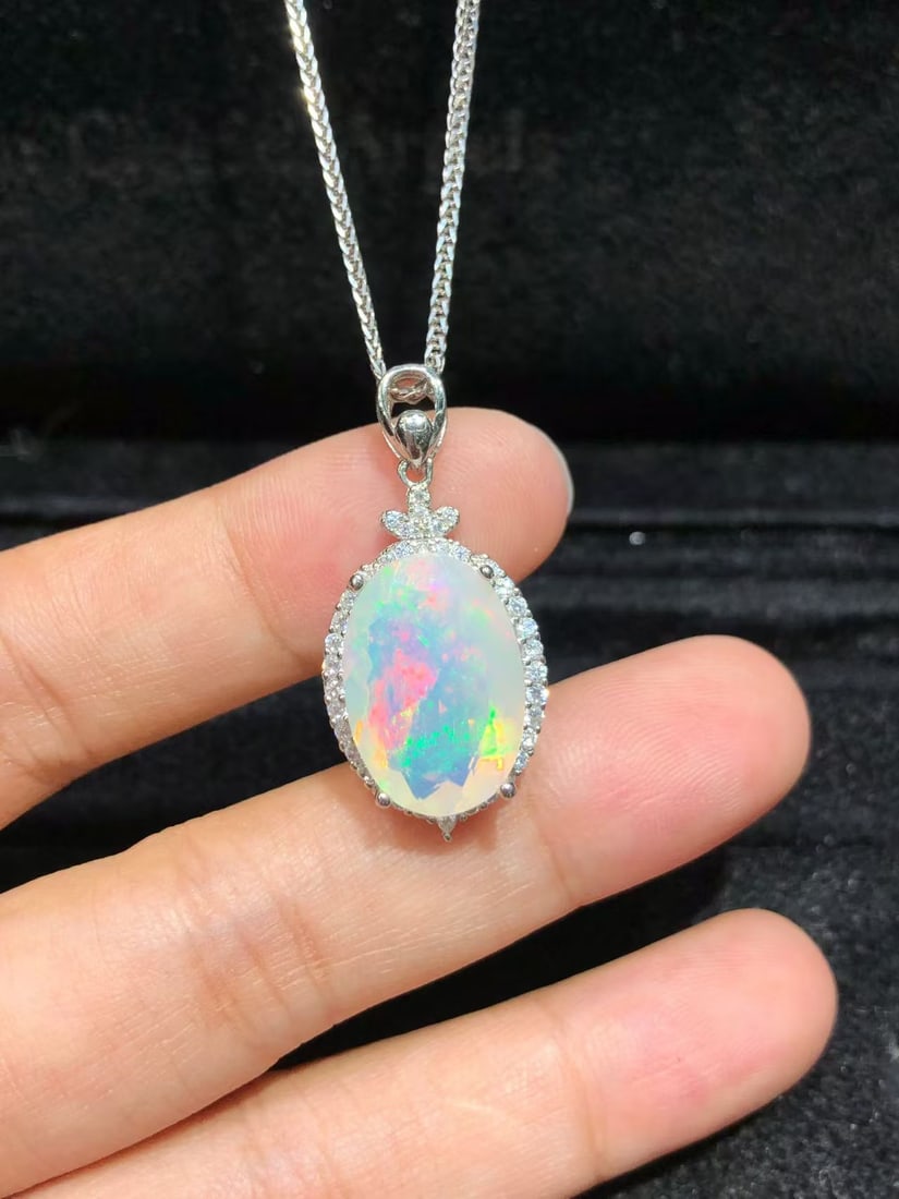 925 sterling silver natural opal pendant: This pendant showcases a natural opal, colorful and exquisitely cut to capture light from every angle. The main stone measures approximately 11x15mm and is set in high-quality S925 sterling silver, kn