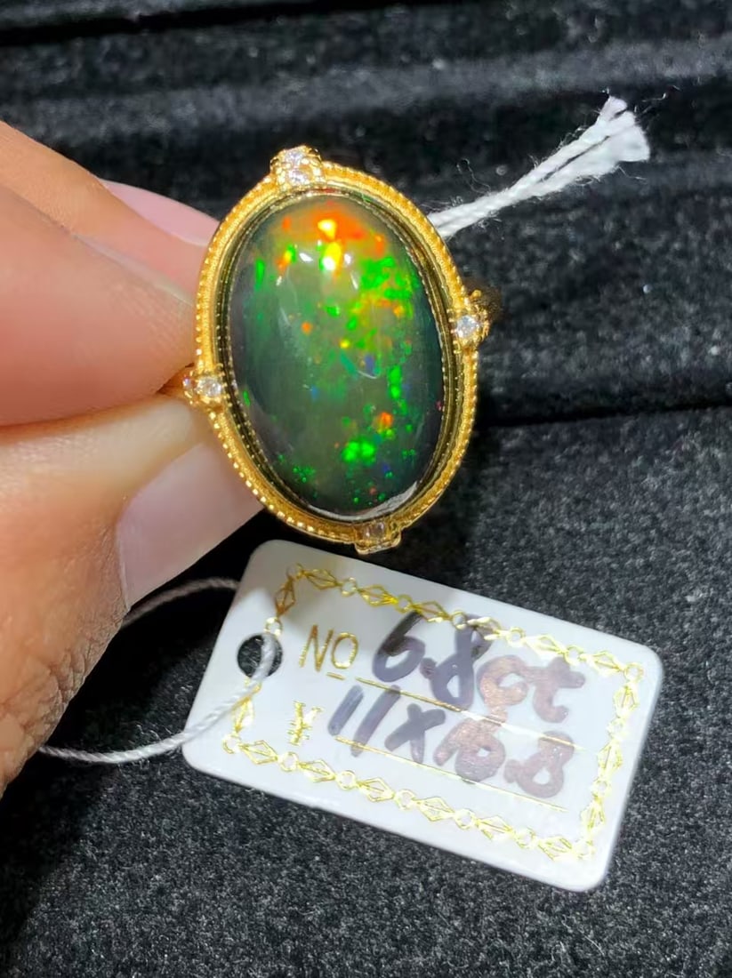 925 sterling silver black opal ring: This stunning ring showcases an impressive natural black opal, with captivating color variations that capture the essence of elegance and nobility. The opal is large in size, measuring 11x16.8 millime