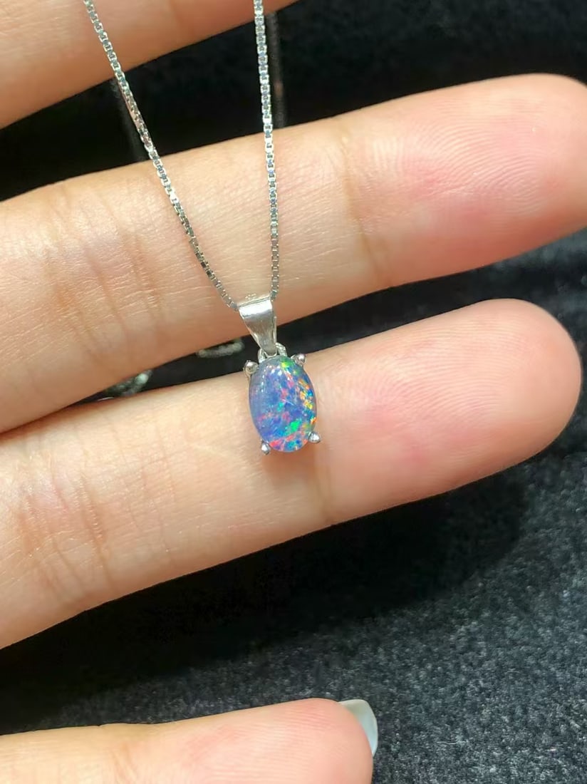 925 sterling silver natural opal pendant: This pendant showcases a stunning natural opal, intricately set in S925 sterling silver. The opal is carefully selected to display its unique beauty, resembling a dazzling starry sky or enchanting aur