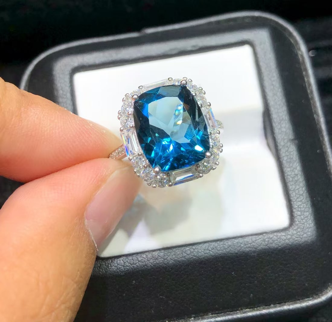 925 Sterling Silver Natural Topaz Ring: This ring showcases the captivating charm of natural topaz, set in shiny 925 sterling silver. The topaz displays a deep blue color, resembling the depth of the sea, expertly crafted into a stunning 10