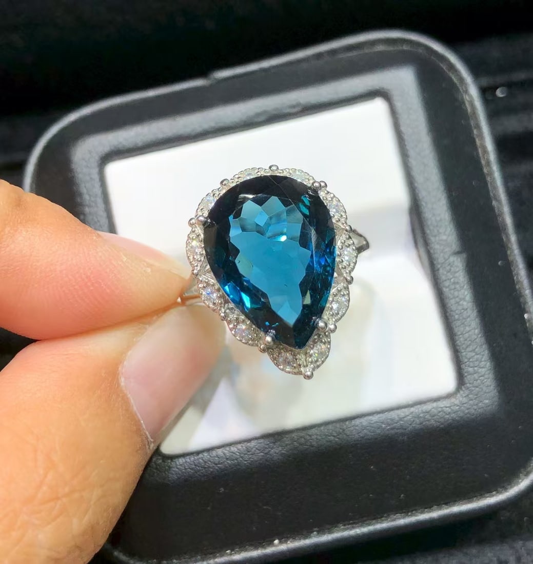 925 sterling silver natural topaz ring: This ring features a stunning natural topaz as the main stone, with a main stone size of 12x16mm, exquisitely set in high-quality S925 sterling silver. The deep blue hue of the topaz complements the s