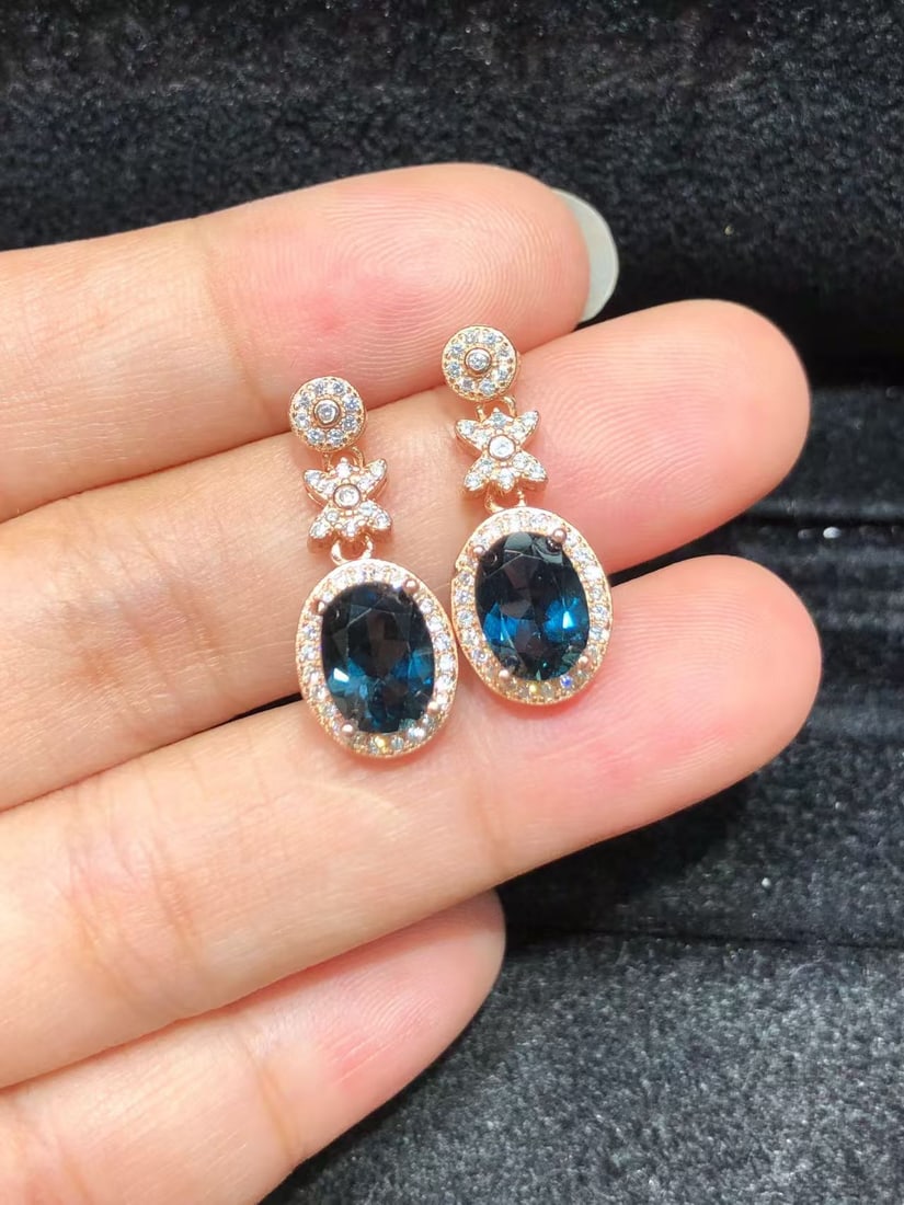 925 sterling silver natural topaz stud earrings: These earrings feature exquisite topaz stones, each carefully set in S925 sterling silver. The deep blue of the topaz complements the shine of the silver, creating a stunning visual effect. The crafts