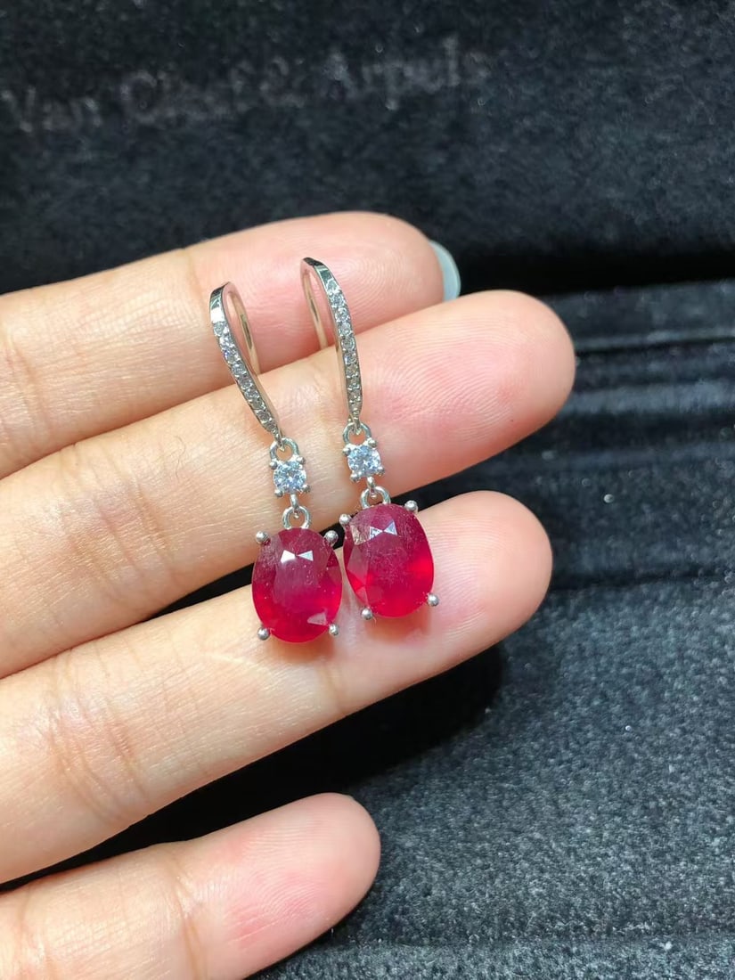 925 sterling silver natural ruby earrings: These earrings showcase the captivating charm of natural rubies, meticulously set in S925 sterling silver. Each earring is set with a 7x9mm ruby, emitting a deep red glow, perfectly embodying passion