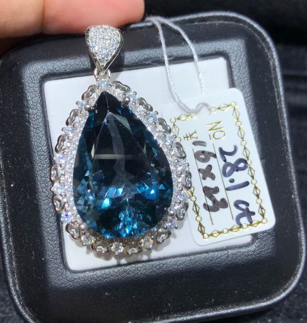 925 sterling silver natural topaz pendant: This pendant showcases a stunning natural topaz stone, finely set in sterling silver. The topaz stone is mesmerizing with its deep oceanic hues, resembling the depths of a calm sea, and has been caref