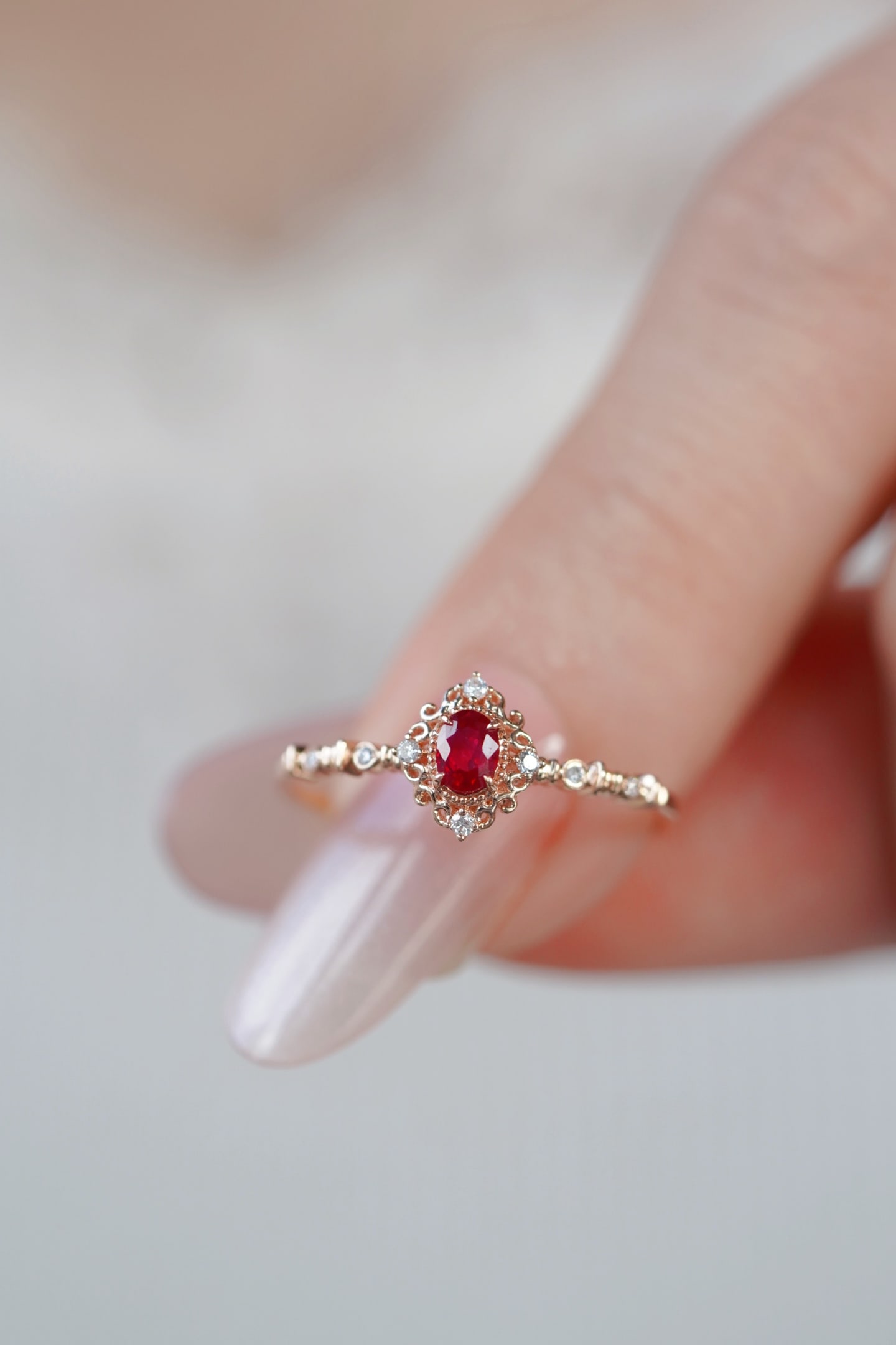18K Gold Natural Ruby Ring: This ring captures the essence of a blooming flower with its brilliant petal design, meticulously crafted using natural rubies. The exquisite craftsmanship is evident, with the ring adorned with a hal