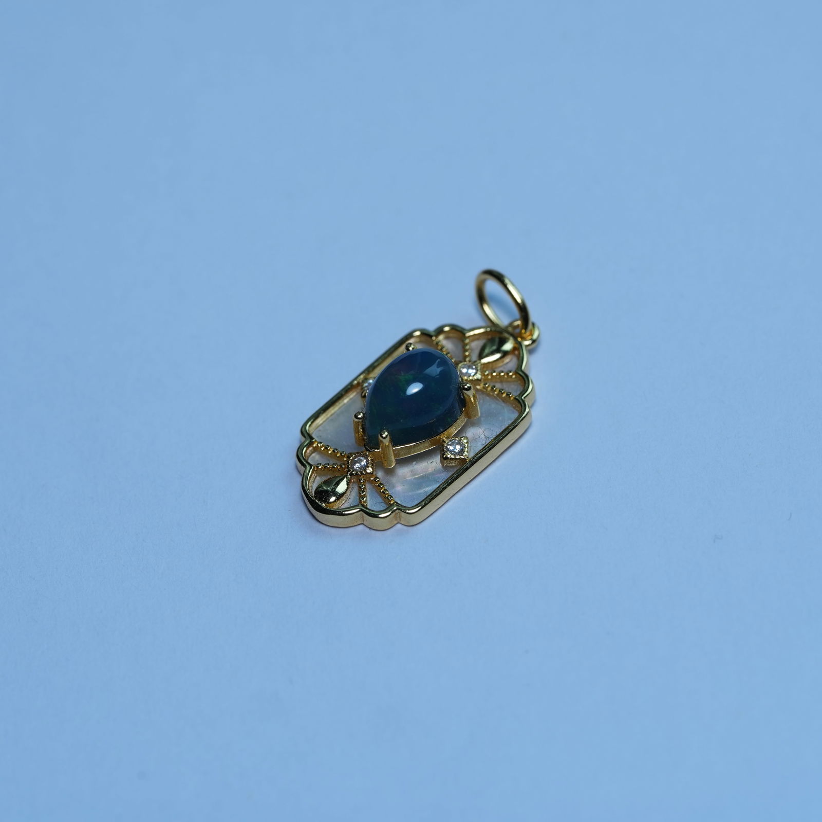 925 Sterling Silver Natural Opal Pendant: This is an exquisitely designed natural opal pendant: the main stone is a teardrop-shaped natural opal with a deep, dark base and a subtle, flowing play of colors (opal's signature "play of colors" te