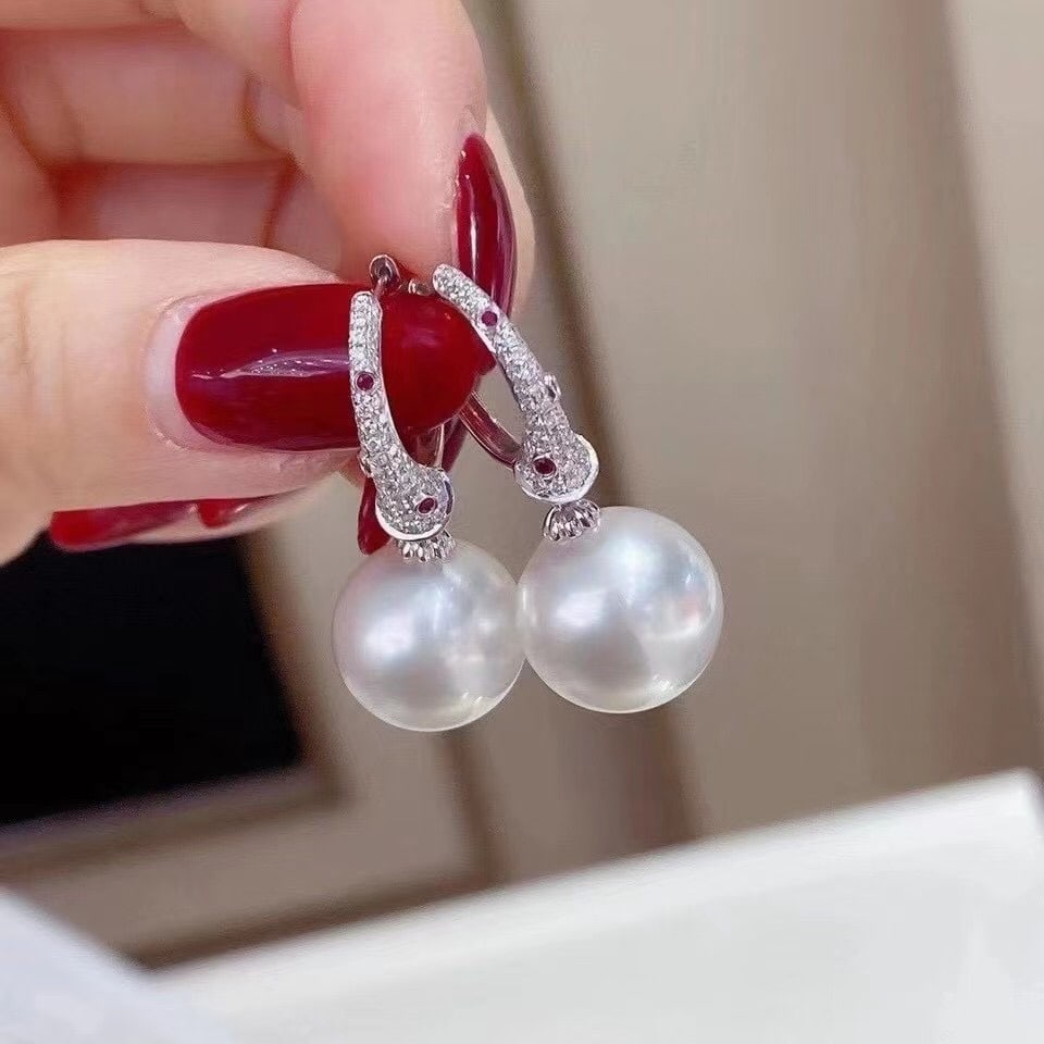 Natural White Pearl Earrings: These earrings showcase the elegant essence with their stunning natural large white pearls. With a large diameter ranging from 11 to 12 millimeters, these pearls emit a captivating radiance that is su