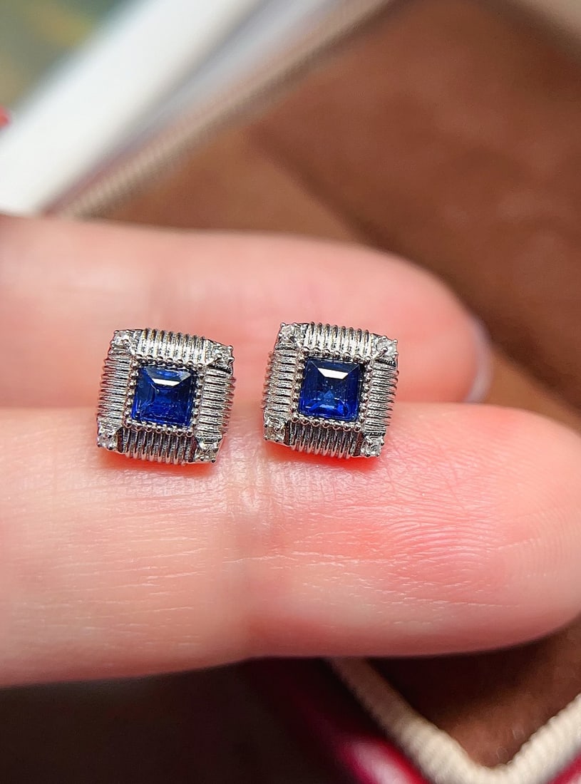18k Gold Sapphire Earrings: These earrings feature a royal blue sapphire as the center stone, cut in a princess square shape, creating a mesmerizing effect. The simple design is elevated by exquisite craftsmanship, making it an