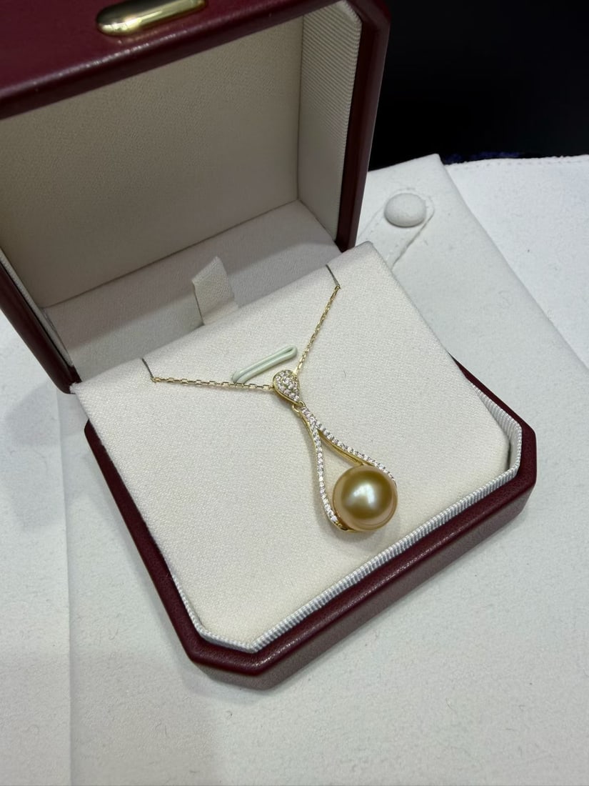 Sterling Silver Golden Pearl Pendant: This gold pearl pendant features a simple yet sophisticated design, perfectly accentuating the neckline. The 11-12mm nearly round gold pearl is of extremely high quality with minimal flaws and strong