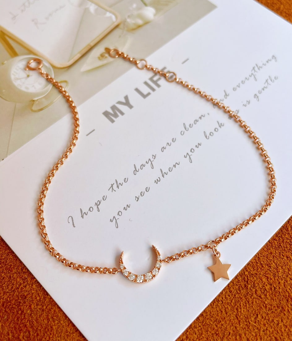 18k Diamond Star and Moon Bracelet: This bracelet captures the enchanting celestial dance between the moon and the stars. Made with exquisite 18k gold and adorned with sparkling diamonds, it exudes a ethereal elegance. The intricate des