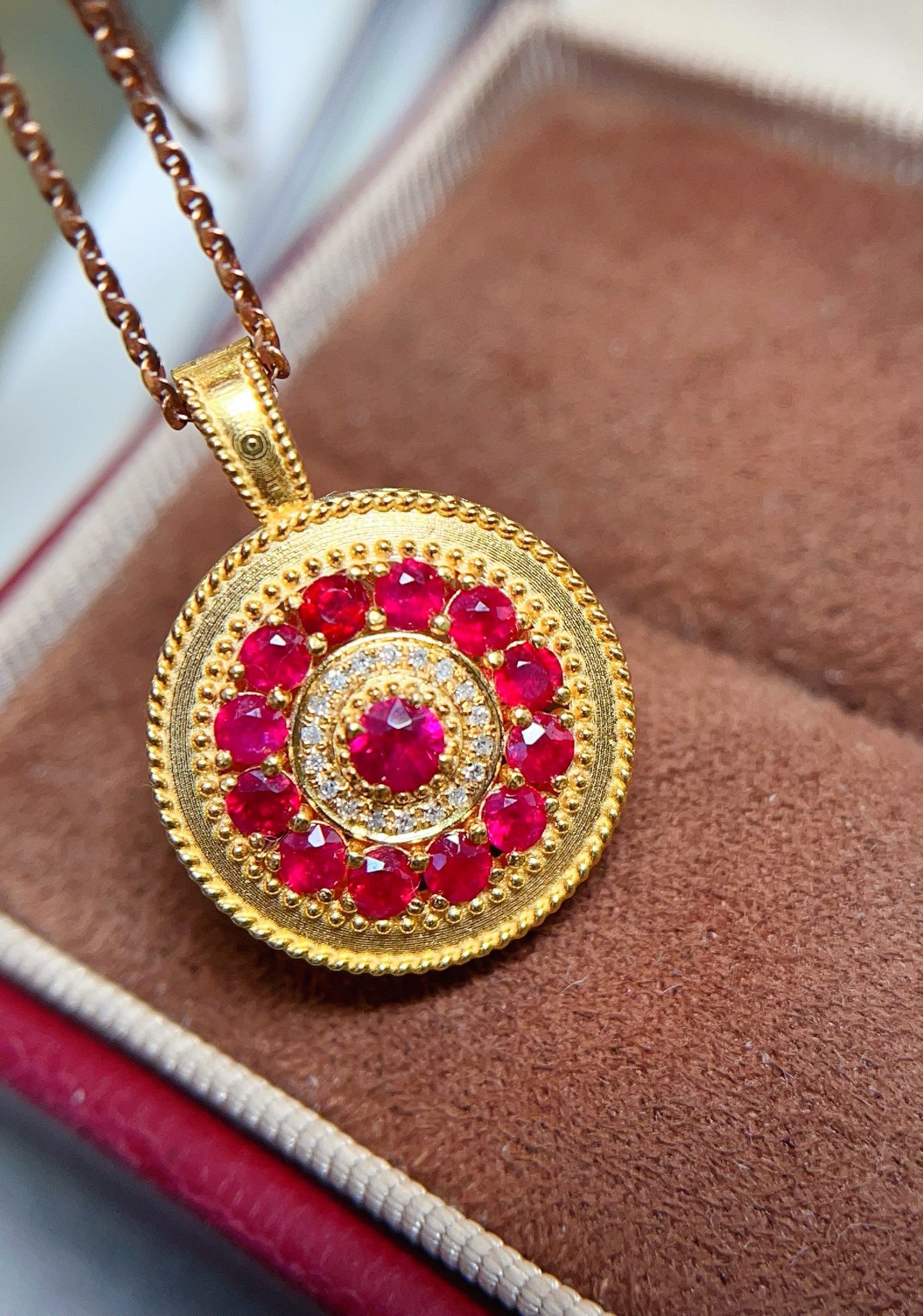 18K Gold Ruby Pendant: This pendant is a symbol of eternal elegance, set with a captivating pigeon blood red ruby, emitting a deep and passionate red color. It showcases a grand Chinese style with delicate ancient craftsman