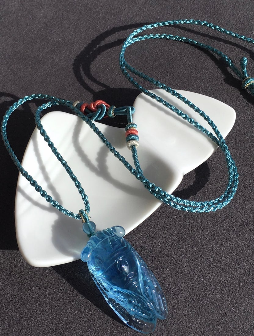 Aquamarine Carved Pendant: This pendant captures the essence of the ocean with its stunning aquamarine, meticulously crafted to perfection. The crystal-clear texture and devilish blue color create a charming effect, making it a