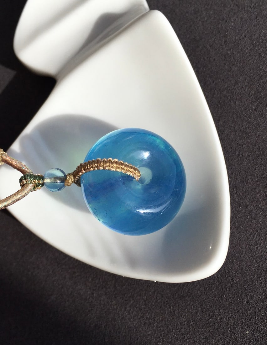 Aquamarine Peace Buckle Pendant: This turquoise Pi Xiu pendant showcases its enchanting devilish blue color and crystal clear texture, perfectly embodying the essence of tranquility and elegance. The transparency of the gem emits a