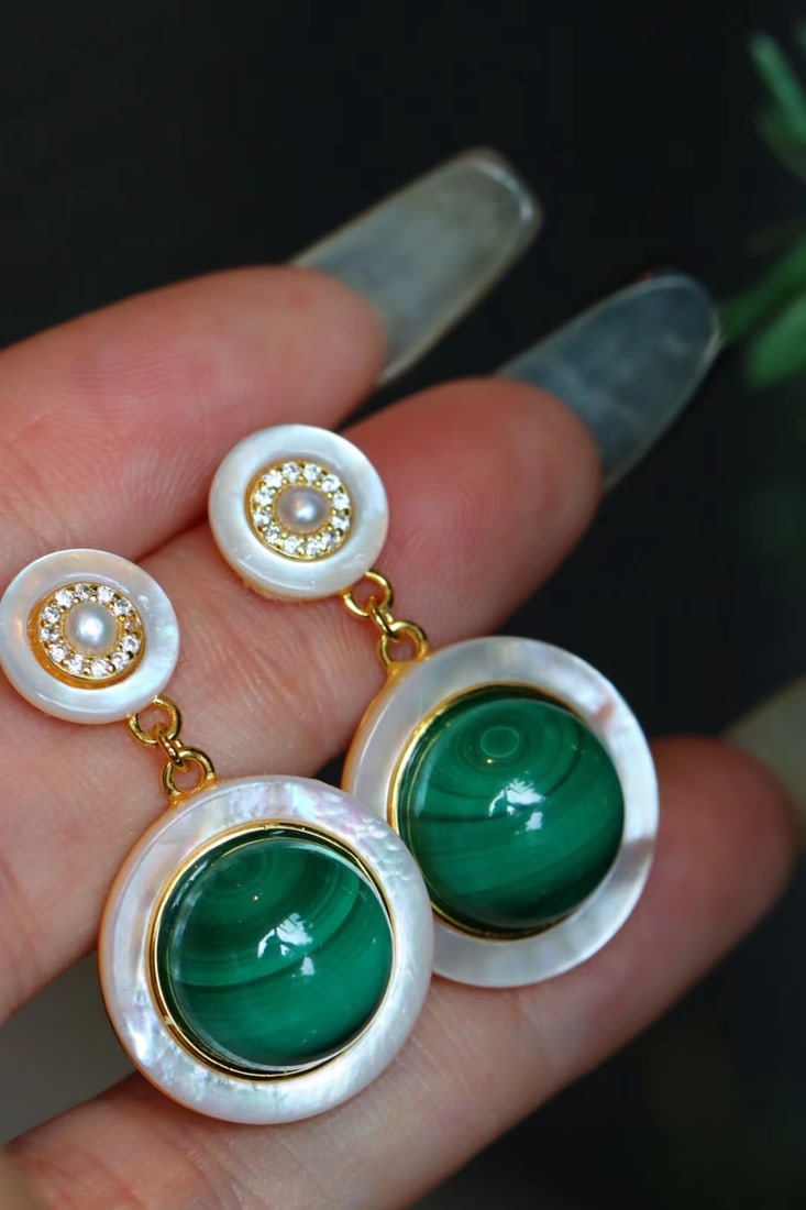 Peacock stone earrings: These earrings feature a full-bodied peacock stone at its core, showcasing a natural elegance and mystery. The peacock stone's perfect round shape is complemented by white mother-of-pearl edging, crea