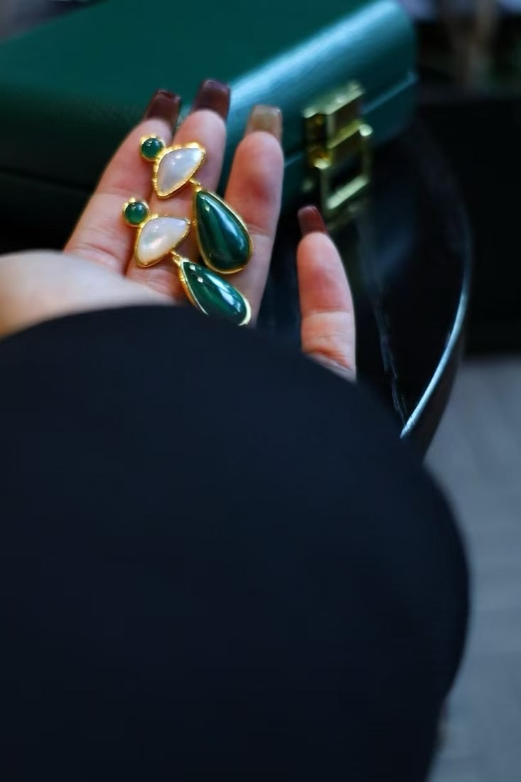 s925 silver plated gold, peacock stone, white mother-of-pearl jade earrings: This peacock stone and white mother-of-pearl jadeite earring has become a favorite of many jewelry enthusiasts due to its simple yet timeless design. The deep green color of the peacock stone compleme