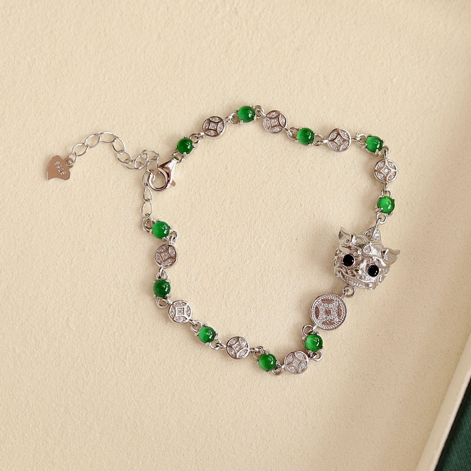 S925 pure silver plated with 18k white gold Jadeite Pixiu bracelet: This bracelet is inspired by the mysterious Eastern mythical creature Pixiu, made of natural Jadeite emitting a charming high ice yang green color, enhancing the wearer's temperament. Pixiu is seen